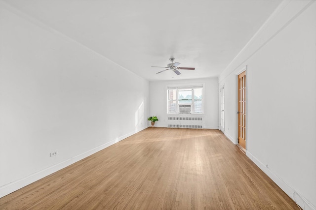 83-33 Austin St Unit 2C, Kew Gardens, NY 11415 - spare room with radiator, wood finished floors, and a ceiling fan
