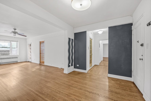83-33 Austin St Unit 2C, Kew Gardens, NY 11415 - unfurnished room featuring radiator, light wood-style flooring, and a ceiling fan