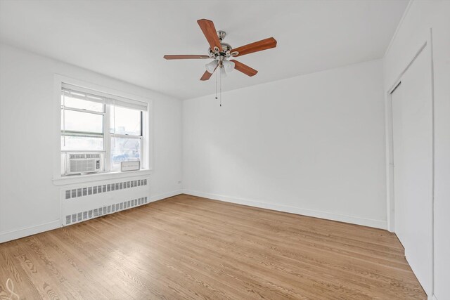 83-33 Austin St Unit 2C, Kew Gardens, NY 11415 - unfurnished room with radiator, light wood finished floors, a ceiling fan, and cooling unit