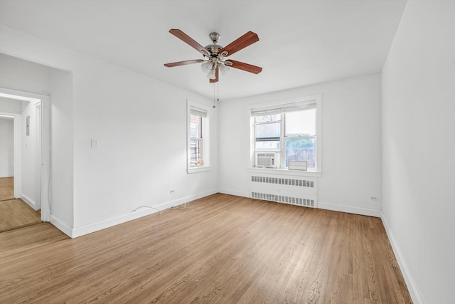 83-33 Austin St Unit 2C, Kew Gardens, NY 11415 - empty room featuring radiator, light wood-type flooring, a ceiling fan, and cooling unit