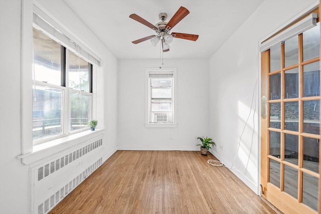 83-33 Austin St Unit 2C, Kew Gardens, NY 11415 - spare room with radiator, light wood finished floors, and ceiling fan