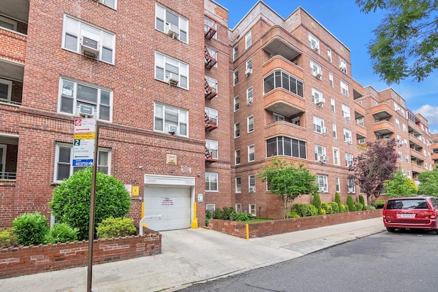 83-33 Austin St Unit 2C, Kew Gardens, NY 11415 - view of apartment building / complex with driveway and a garage