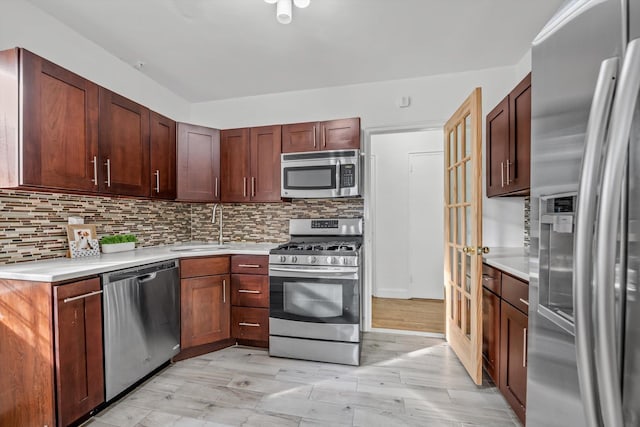 83-33 Austin St Unit 2C, Kew Gardens, NY 11415 - kitchen featuring appliances with stainless steel finishes, light countertops, and backsplash
