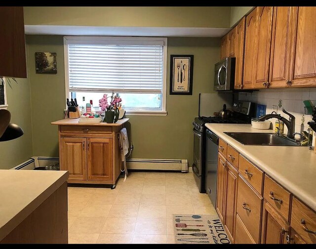 3 Malmac Ct, West Islip, NY 11795 - kitchen with baseboard heating, appliances with stainless steel finishes, brown cabinets, light countertops, and decorative backsplash