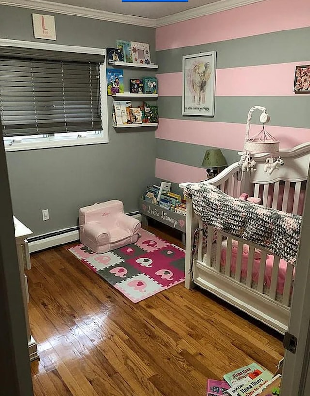 3 Malmac Ct, West Islip, NY 11795 - bedroom featuring a baseboard radiator, crown molding, wood finished floors, a nursery area, and baseboard heating