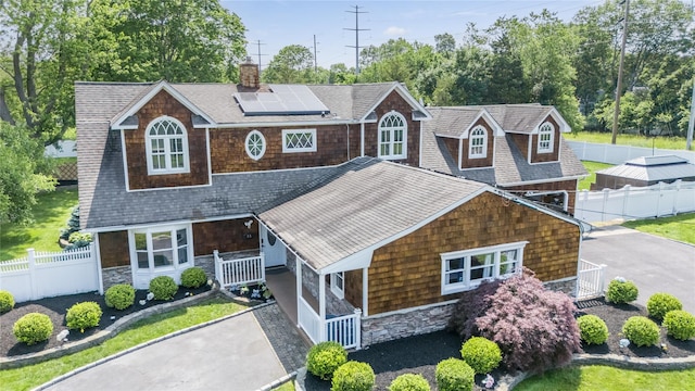 55 Charm City Dr, Port Jefferson Station, NY 11776 - shingle-style home with solar panels, a shingled roof, driveway, and stone siding