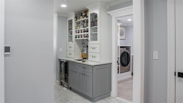 55 Charm City Dr, Port Jefferson Station, NY 11776 - washroom with wine cooler, washer / dryer, bar area, recessed lighting, and crown molding