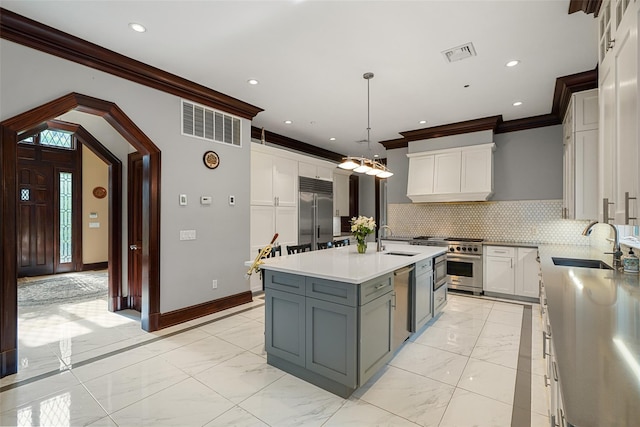 3747 Purchase St, Purchase, NY 10577 - kitchen featuring premium appliances, crown molding, light marble finish flooring, light countertops, and backsplash
