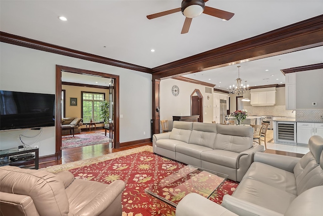 3747 Purchase St, Purchase, NY 10577 - living room featuring wine cooler, ornamental molding, light wood-style floors, a chandelier, and ceiling fan