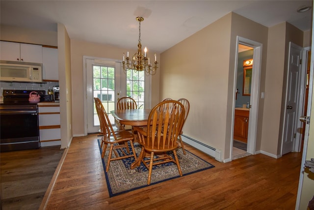 805 Canal Rd, Mount Sinai, NY 11766 - dining area with a baseboard radiator, a chandelier, and wood finished floors