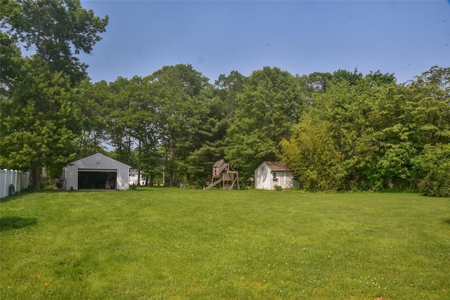 805 Canal Rd, Mount Sinai, NY 11766 - view of yard featuring an outbuilding, a detached garage, and a playground