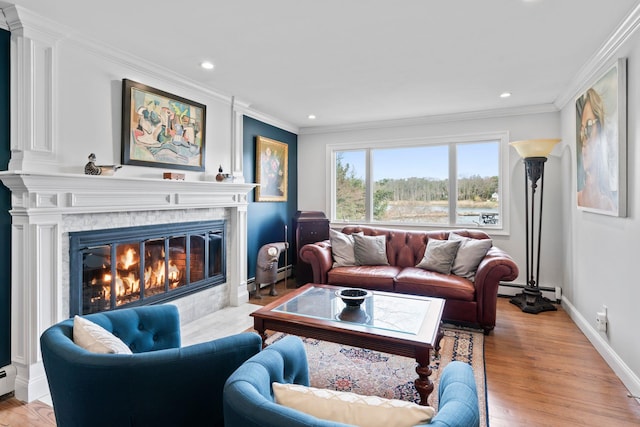 8 Pippin Ln, Lloyd Harbor, NY 11743 - living room featuring a glass covered fireplace, crown molding, recessed lighting, light wood-style floors, and a baseboard radiator
