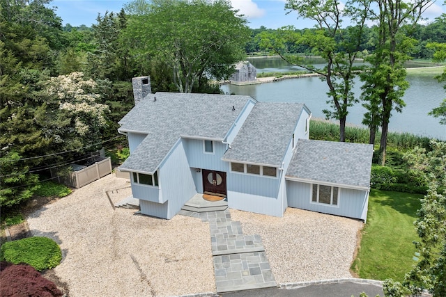 8 Pippin Ln, Lloyd Harbor, NY 11743 - view of front of property with a water view, a chimney, and roof with shingles