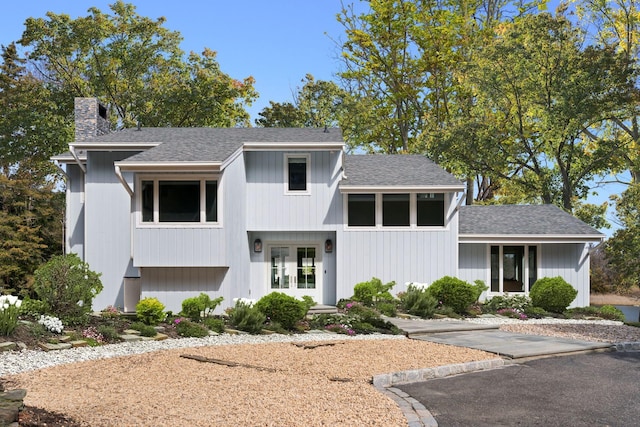 8 Pippin Ln, Lloyd Harbor, NY 11743 - view of front of house featuring a chimney and a shingled roof