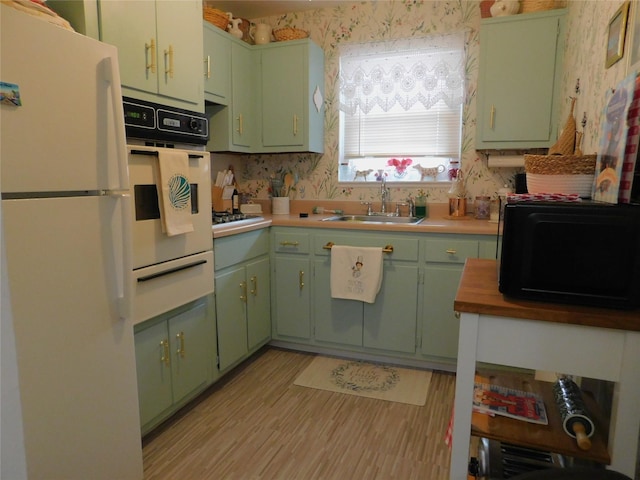 1879 Crompond Rd Unit # D15, Peekskill, NY 10566 - kitchen featuring white appliances, a warming drawer, green cabinets, and wallpapered walls