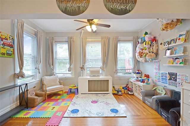 3070 Lasalle Ave, Bronx, NY 10461 - recreation room featuring wood finished floors, radiator, and plenty of natural light