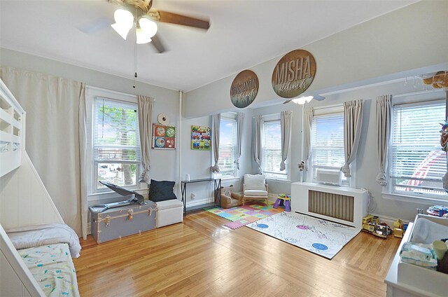 3070 Lasalle Ave, Bronx, NY 10461 - playroom with wood finished floors, ceiling fan, and radiator