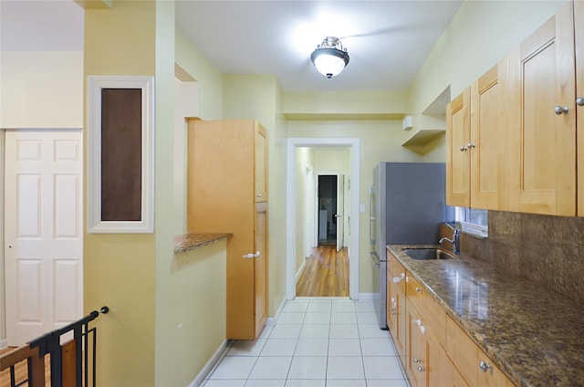 3070 Lasalle Ave, Bronx, NY 10461 - kitchen with light tile patterned flooring, light brown cabinetry, dark stone counters, and decorative backsplash