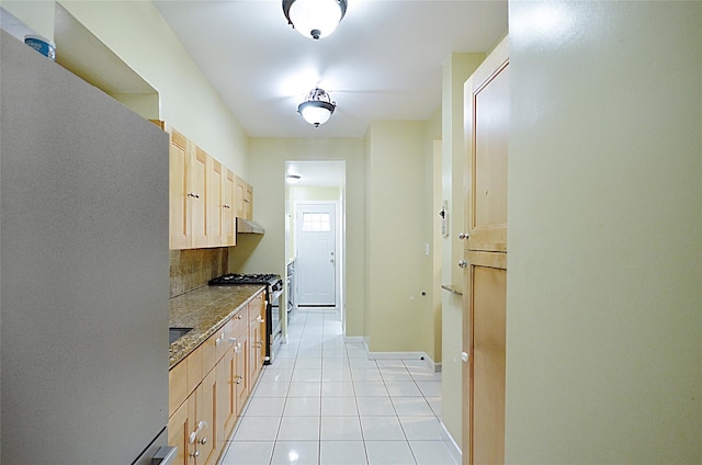 3070 Lasalle Ave, Bronx, NY 10461 - kitchen featuring stainless steel appliances, light brown cabinetry, light tile patterned flooring, under cabinet range hood, and backsplash