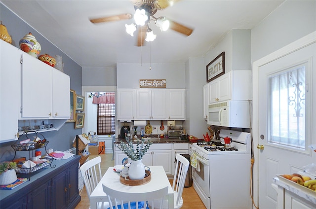 3070 Lasalle Ave, Bronx, NY 10461 - kitchen with white appliances, white cabinets, and ceiling fan