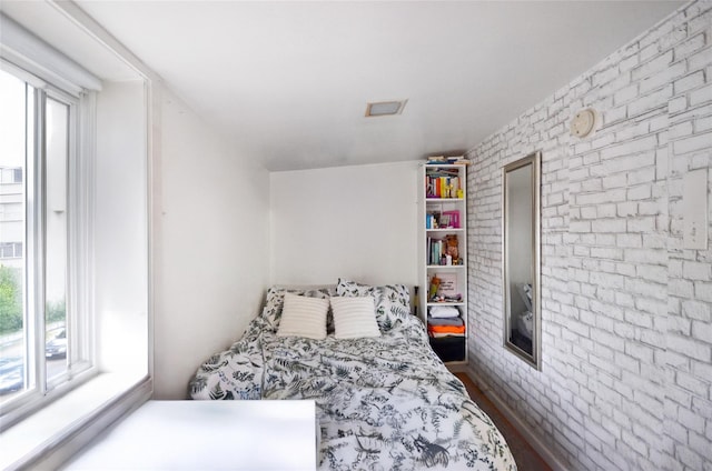3070 Lasalle Ave, Bronx, NY 10461 - bedroom with brick wall and dark wood-style flooring