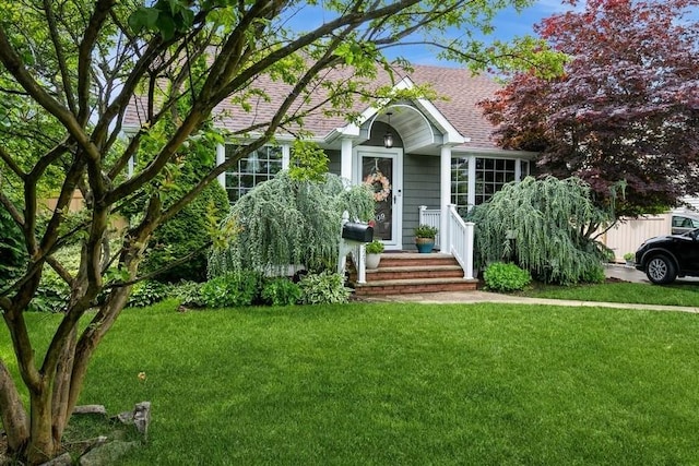 2209 Post St, East Meadow, NY 11554 - view of front of property with a front yard and a shingled roof