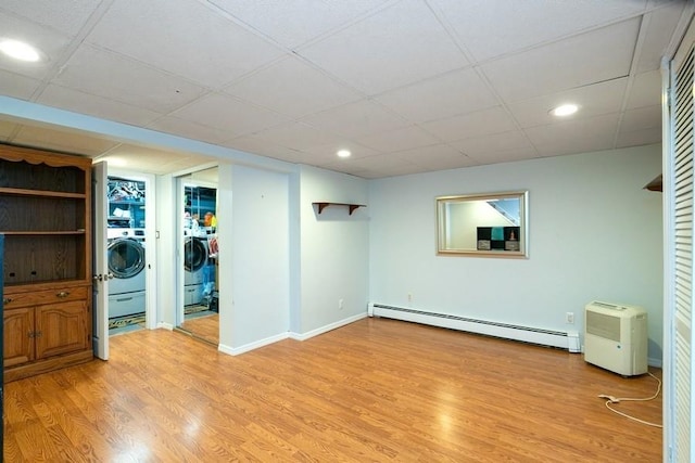 2209 Post St, East Meadow, NY 11554 - finished basement featuring a baseboard heating unit, light wood-style floors, recessed lighting, washer / clothes dryer, and a paneled ceiling