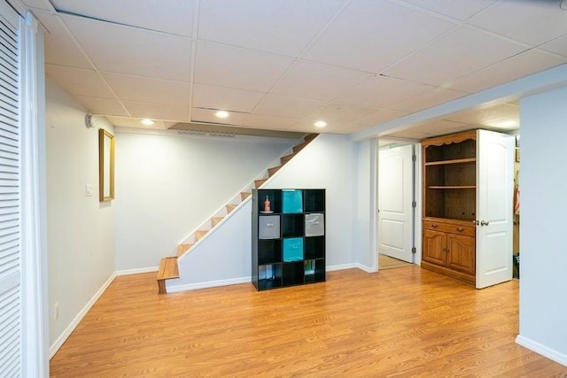 2209 Post St, East Meadow, NY 11554 - finished below grade area featuring stairs, light wood-style flooring, a drop ceiling, and recessed lighting
