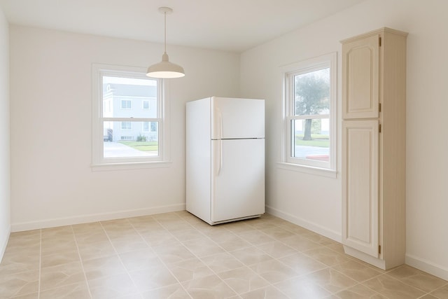 26 Sherman Rd, Farmingdale, NY 11735 - kitchen with freestanding refrigerator, pendant lighting, and light tile patterned flooring