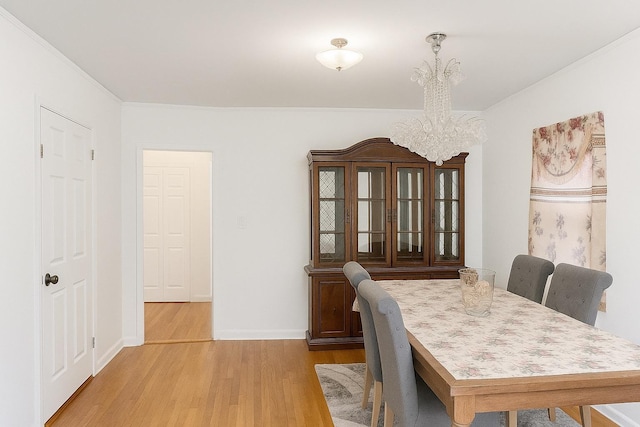 26 Sherman Rd, Farmingdale, NY 11735 - dining space featuring a chandelier, wood finished floors, and ornamental molding
