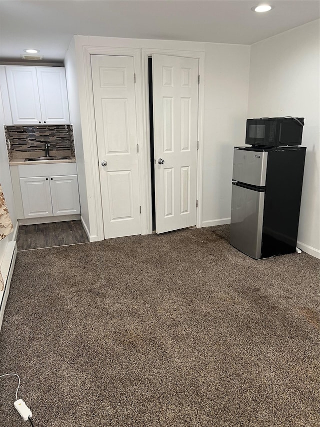26 Sherman Rd, Farmingdale, NY 11735 - kitchen featuring freestanding refrigerator, white cabinetry, recessed lighting, black microwave, and backsplash