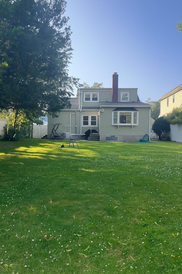 26 Sherman Rd, Farmingdale, NY 11735 - rear view of house featuring entry steps and a chimney