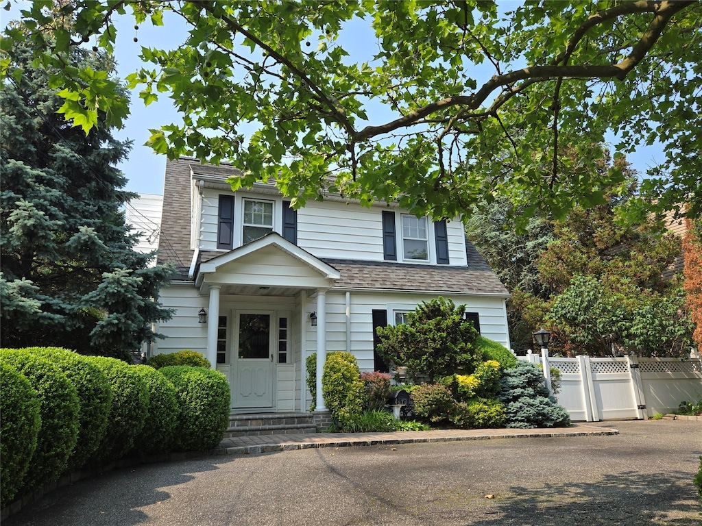 1277 Jerusalem Ave, Merrick, NY 11566 - view of front facade featuring a chimney and roof with shingles