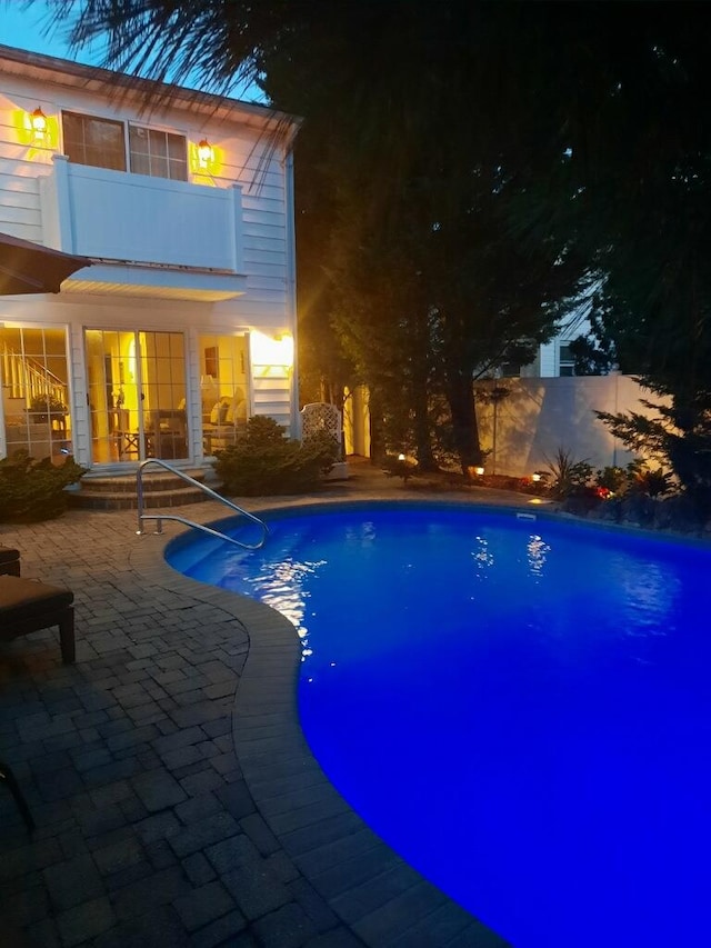 1277 Jerusalem Ave, Merrick, NY 11566 - pool at night featuring a patio area