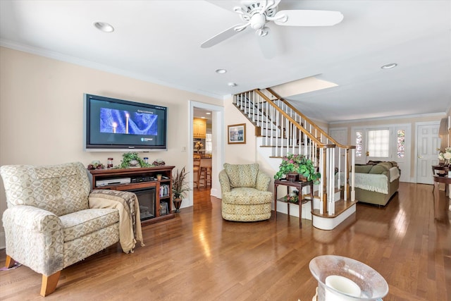 1277 Jerusalem Ave, Merrick, NY 11566 - living area with crown molding, stairway, wood finished floors, a ceiling fan, and a glass covered fireplace