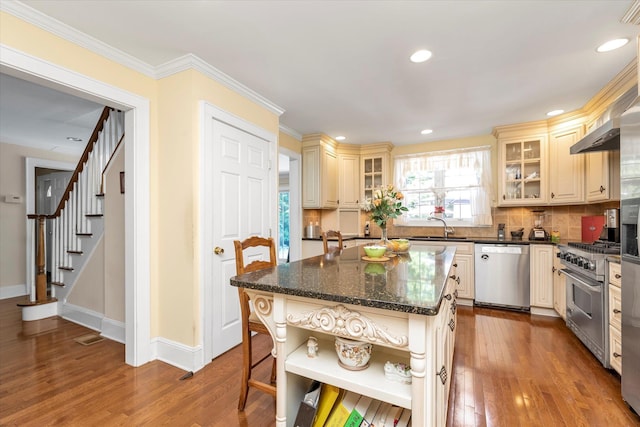 1277 Jerusalem Ave, Merrick, NY 11566 - kitchen featuring appliances with stainless steel finishes, cream cabinetry, open shelves, wood finished floors, and recessed lighting