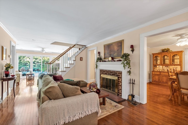 1277 Jerusalem Ave, Merrick, NY 11566 - living area featuring ceiling fan, a fireplace, wood finished floors, crown molding, and stairway