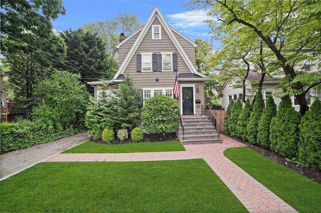 10 Wiltshire St, Bronxville, NY 10708 - view of front of home with a chimney and a front yard