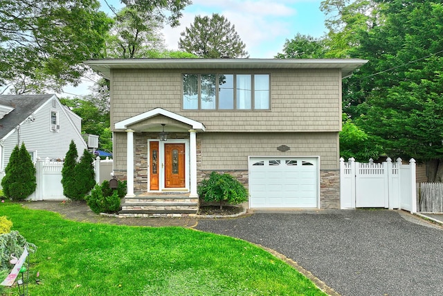36 Dawes Ave, Syosset, NY 11791 - view of front facade with stone siding, a garage, and driveway