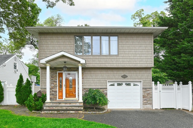 36 Dawes Ave, Syosset, NY 11791 - view of front facade with stone siding, a garage, and driveway