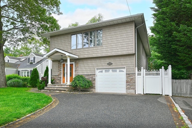 36 Dawes Ave, Syosset, NY 11791 - view of front of home featuring a garage, stone siding, and driveway