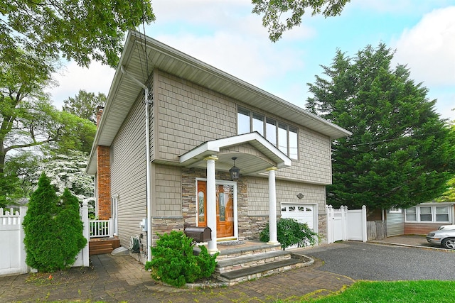 36 Dawes Ave, Syosset, NY 11791 - view of front facade featuring an attached garage, asphalt driveway, and stone siding
