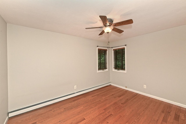 36 Dawes Ave, Syosset, NY 11791 - unfurnished room featuring a baseboard heating unit, wood finished floors, and a ceiling fan