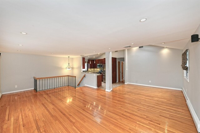 36 Dawes Ave, Syosset, NY 11791 - unfurnished living room with recessed lighting and light wood-type flooring