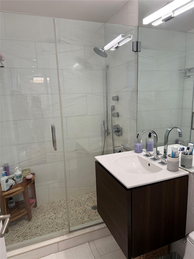 18-05 215th St Unit 2G, Bayside, NY 11360 - bathroom with a stall shower, tile walls, vanity, and tile patterned flooring