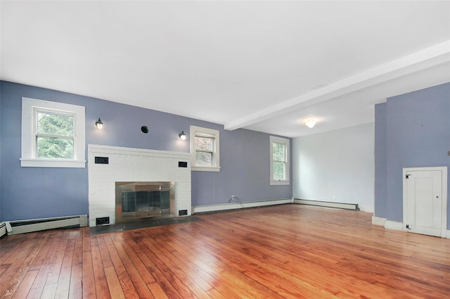 28 Gobblers Knob Rd, Pawling, NY 12564 - unfurnished living room with hardwood / wood-style floors, a brick fireplace, and baseboard heating