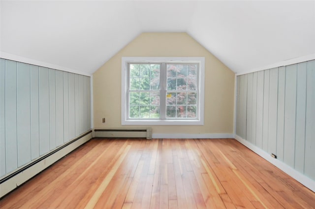 28 Gobblers Knob Rd, Pawling, NY 12564 - additional living space with a baseboard radiator, light wood-style flooring, vaulted ceiling, and wood walls