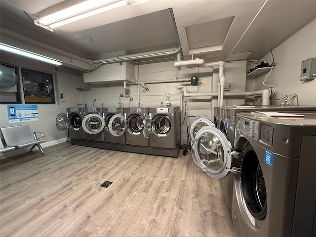 58-03 Calloway St Unit 3Ee, Corona, NY 11369 - shared laundry room with independent washer and dryer and light wood finished floors
