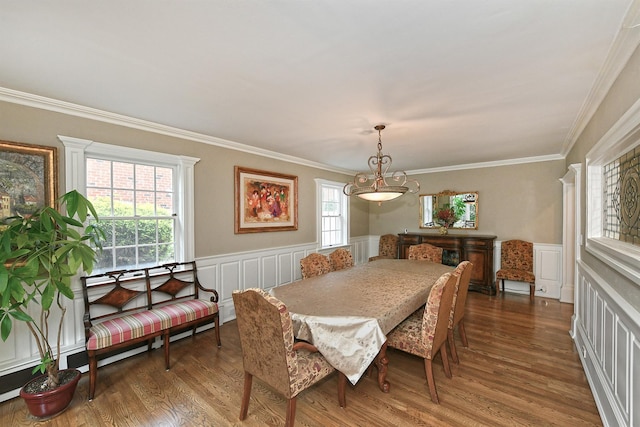 3223 214th St, Bayside, NY 11361 - dining room featuring wood finished floors, ornamental molding, a wainscoted wall, a decorative wall, and a chandelier