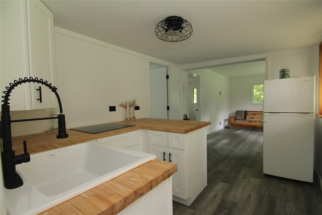 191 Sylvan Lake Rd Unit 1, Hopewell Junction, NY 12533 - kitchen featuring freestanding refrigerator, butcher block counters, a peninsula, white cabinetry, and dark wood-type flooring